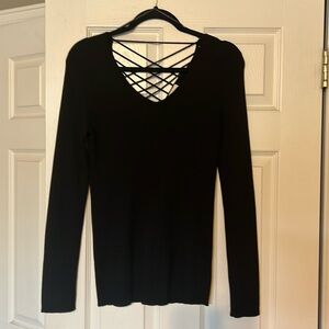 Stylish black sweater with open back/criss cross detailing. New without tags.